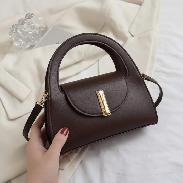 Cream dome-shaped satchel with gold hardware